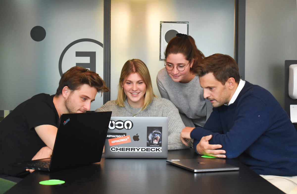 Agency team reviewing designs on a laptop